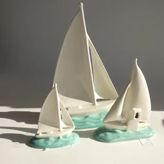 A graduated set of three Poole yachts